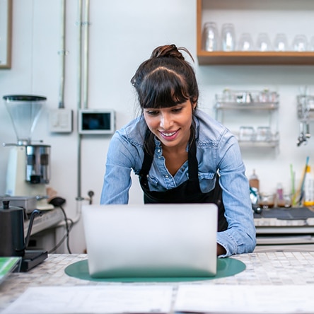 a woman sitting at a table using a laptop