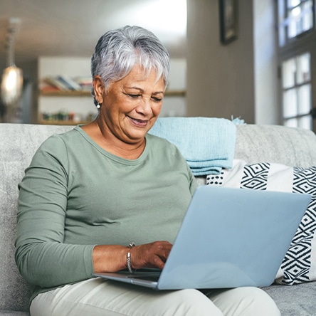 a woman sitting at a table using a laptop