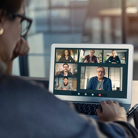 a group of people looking at a laptop