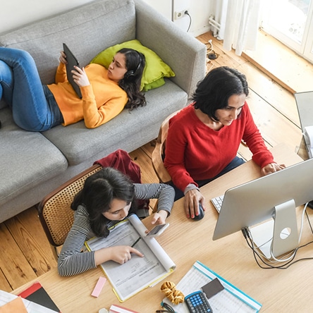 a group of people sitting at a table with a laptop